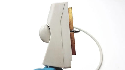 White plastic doorbell with gold metal plate and white cord shown as medical equipment back side for acuson c3 needle guide convex