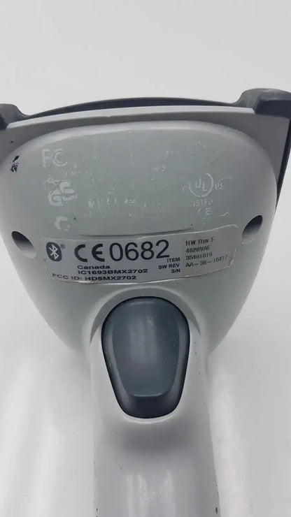 Back side of gray adaptis handheld hd5mx2702 bluetooth bar code scanner with black trigger and certification labels visible