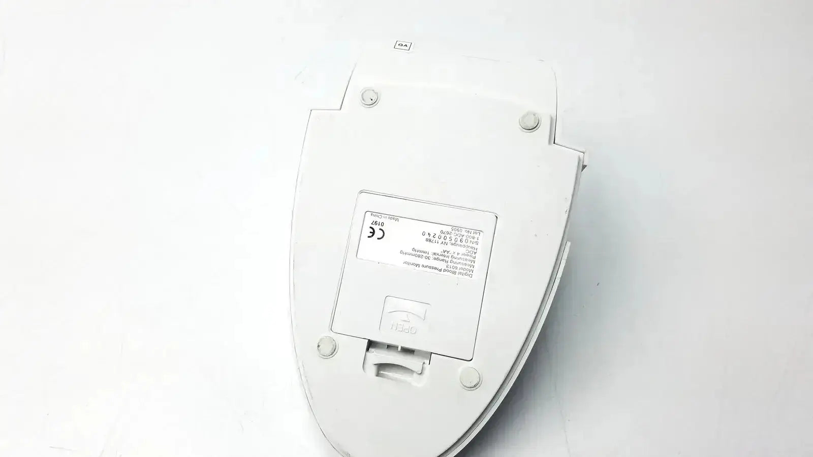 White plastic toilet seat cover with rectangular label and four circular mounts for adc advantage 6013 digital blood pressure monitor back side untested