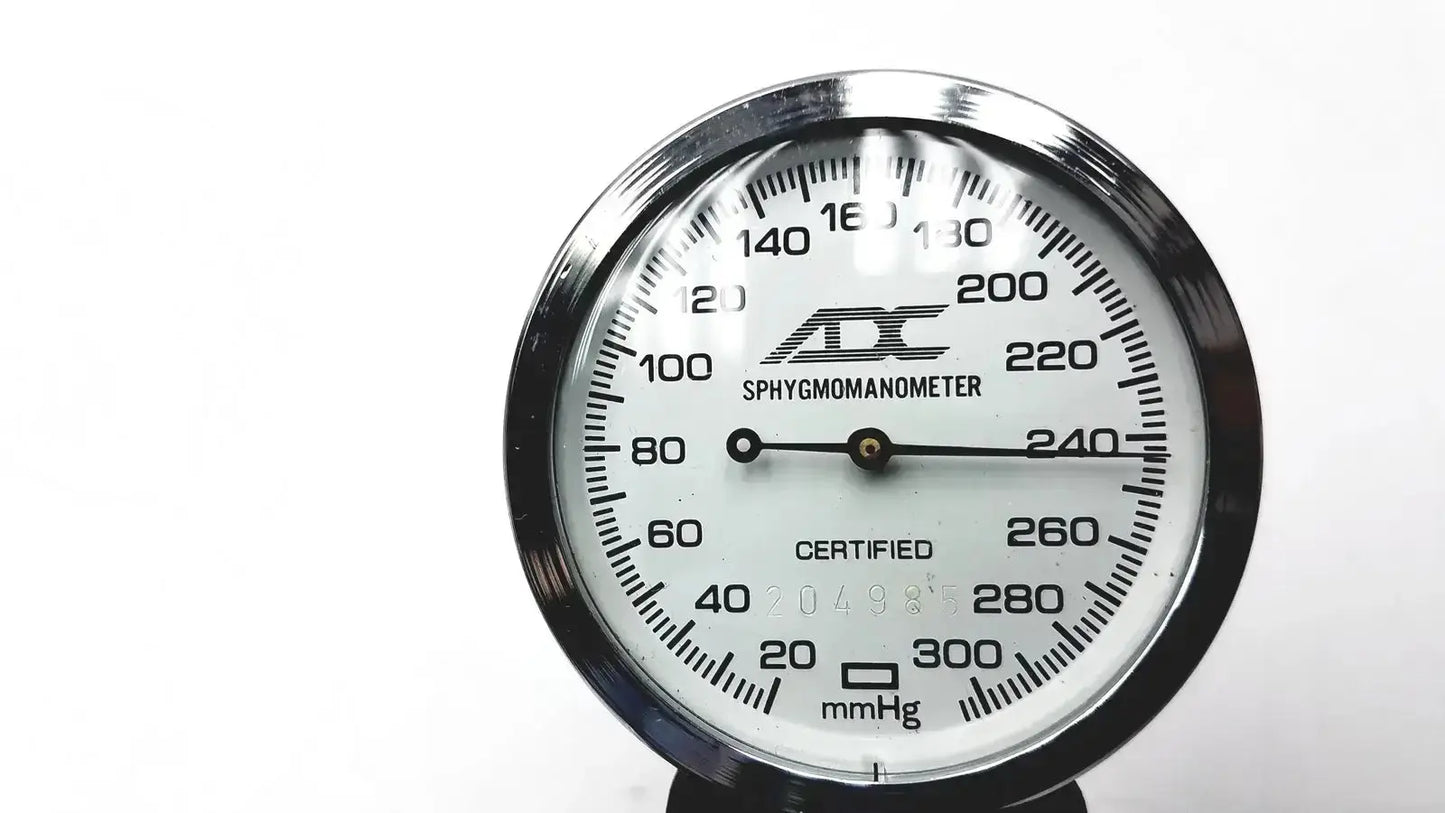 Silver-framed ADC gauge aneroid sphygmomanometer manual with white dial and black mmhg numerals for blood pressure monitoring
