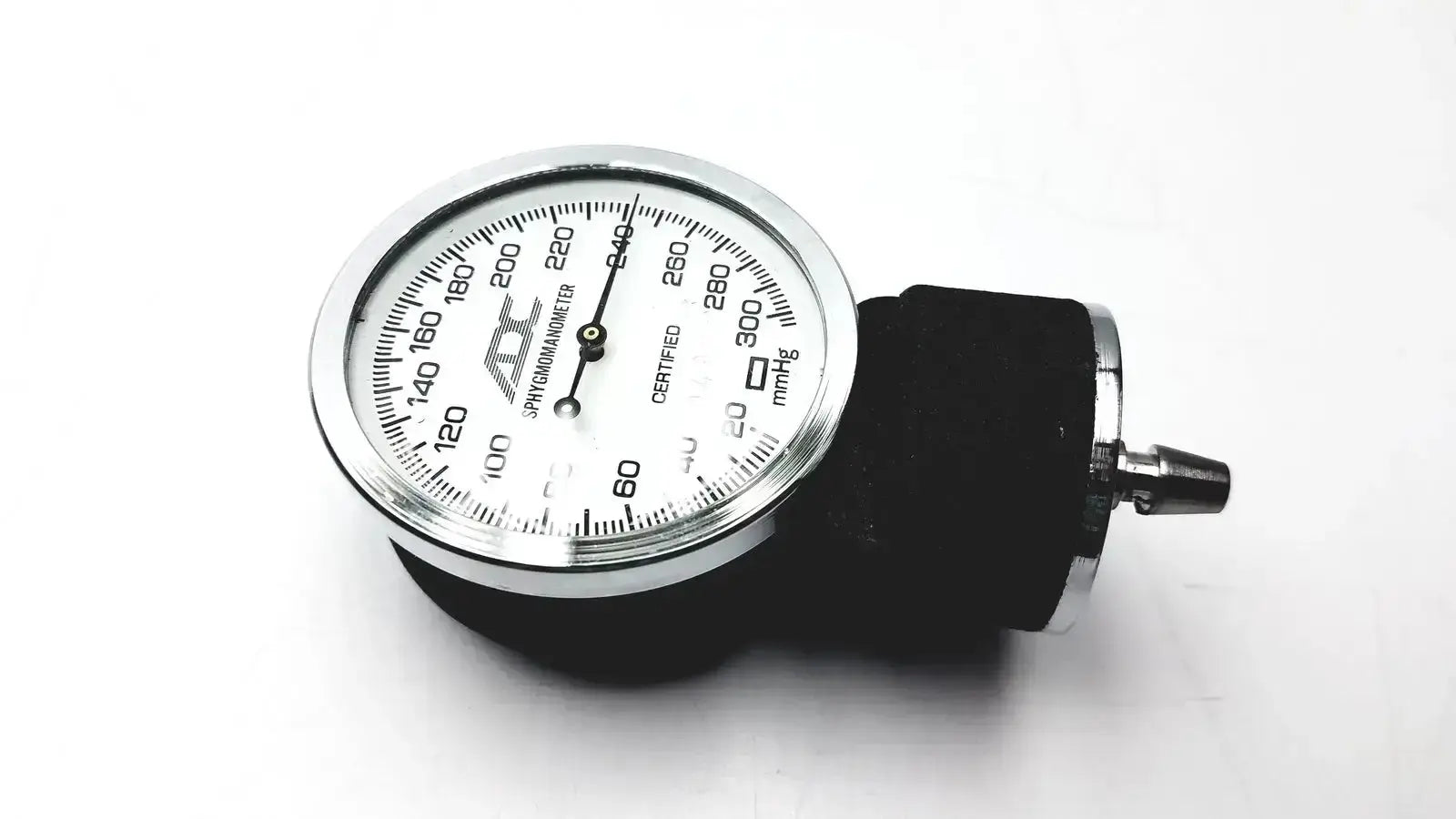 Silver-framed aneroid sphygmomanometer manual blood pressure monitor with white dial and black rubber cuff by ADC gauge