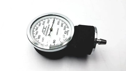 Silver-framed aneroid sphygmomanometer manual blood pressure monitor with white dial and black rubber cuff by ADC gauge