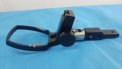 Adjustable flash gun bracket with black metal tripod mount, silver adjustment knob, and rectangular base plate for medical equipment reuse