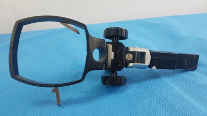 Adjustable flash gun bracket with black plastic and metal microscope stage and knobs for precise positioning medical equipment