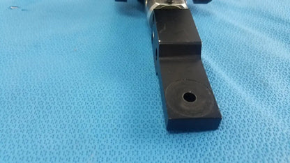 Black rectangular adjustable flash gun bracket with circular hole and metallic joint for reuse medical equipment mounting