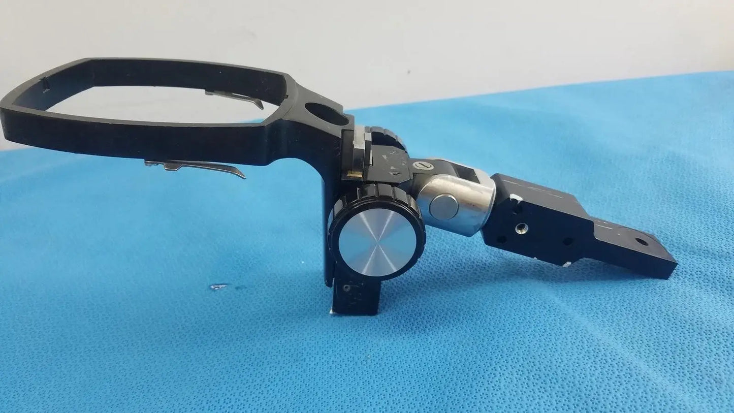 Adjustable flash gun bracket with black and silver metal tripod head and circular dial for precise angle control