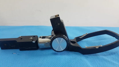 Adjustable flash gun bracket in black and silver with circular knob for secure clamp reuse medical equipment use