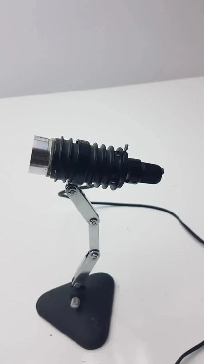 Black adjustable microscope illuminator with flexible silver metal arm and textured black head for precise lighting