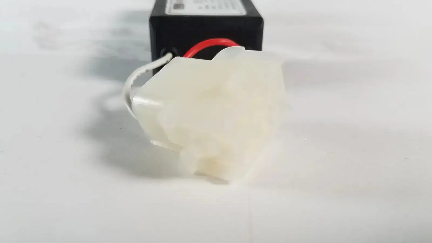 White plastic connector with red and white wires attached to black rectangular advanced sterilization products light power supply