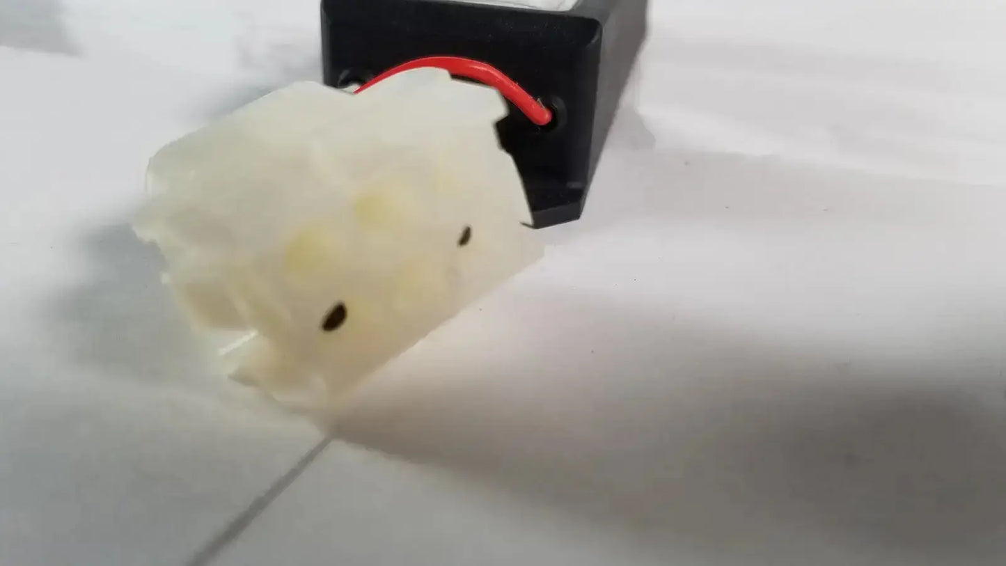Off-white plastic light power supply with black indentations and red wire attached to black component for advanced sterilization products