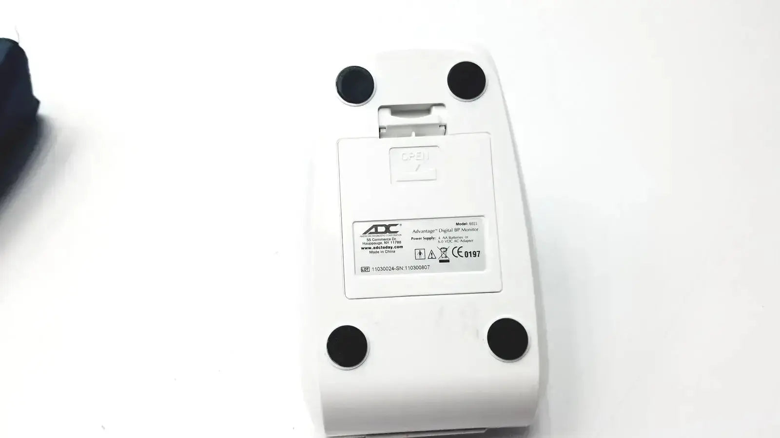 White plastic digital bp monitor mouse with black feet and aoc label from advantage digital bp monitor 6021