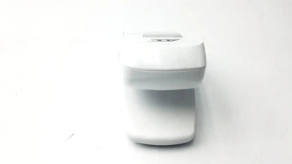 White plastic baby bottle warmer with sleek design and digital display shown alongside adc advantage digital bp monitor 6021 untested