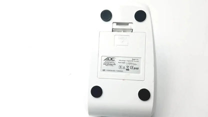 White plastic a4tech digital mp3 player with black feet and silver hinge shown with adc advantage digital bp monitor 6021 untested