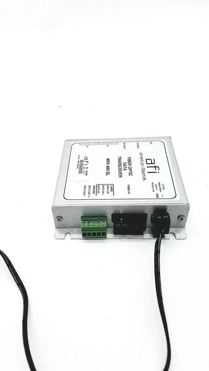 Silver metallic american fibertek mrx-480-sl optic data transceiver with green terminal block and black connectors back view