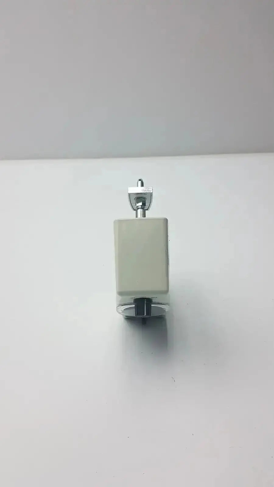 A compact white plastic allied healthcare vacutron suction regulator with metallic silver top and black base