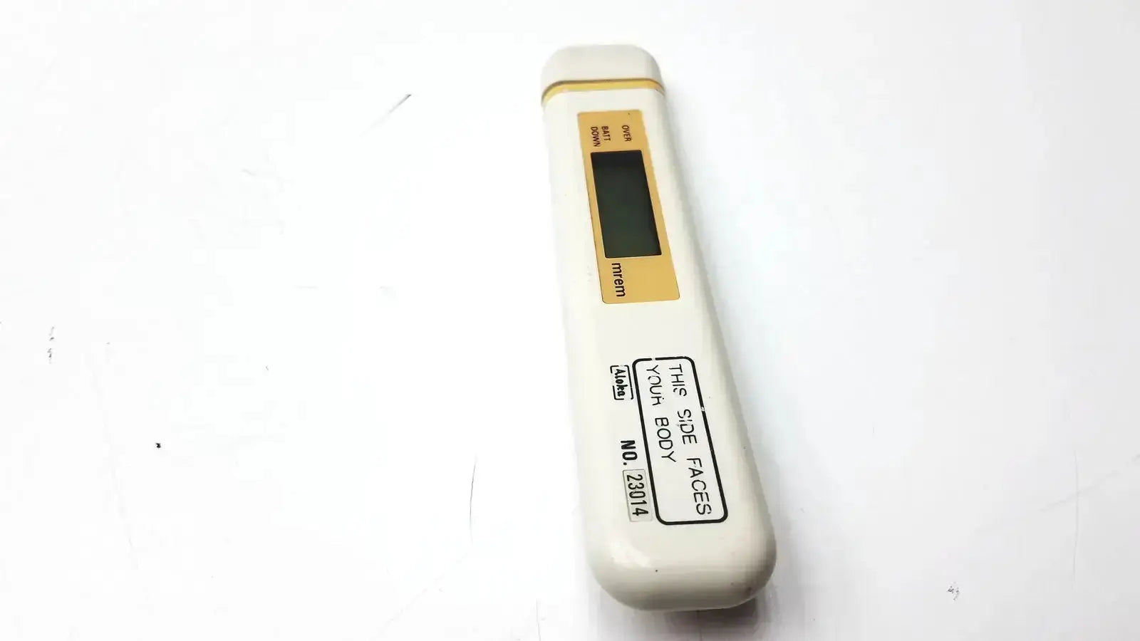 White digital mydose mini dosimeter with gold display panel and black text labeling aloka pdm-253 mydose mini dosimeter