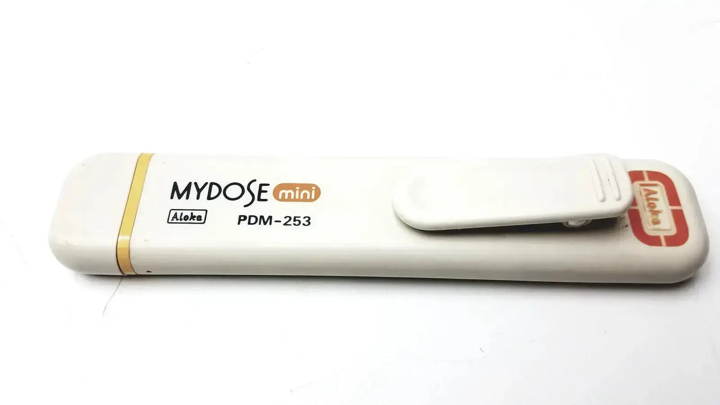 White plastic mydose mini dosimeter with yellow accent stripe and red logo on clip from aloka pdm-253 series