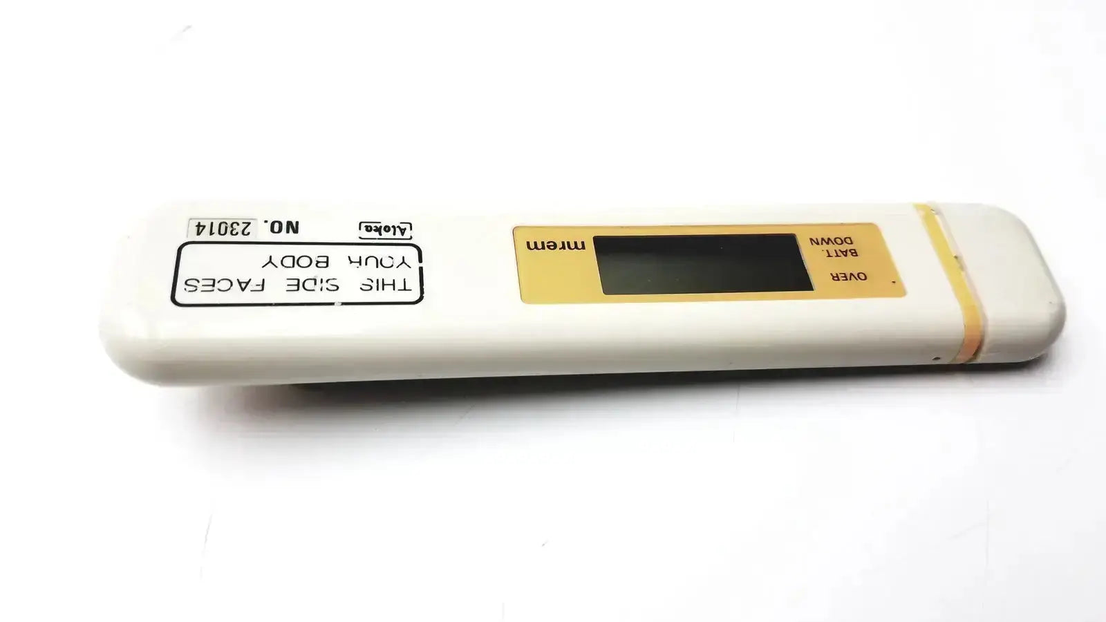 White and yellow aloka pdm-253 mydose mini dosimeter digital caliper with rectangular screen labeled mrem