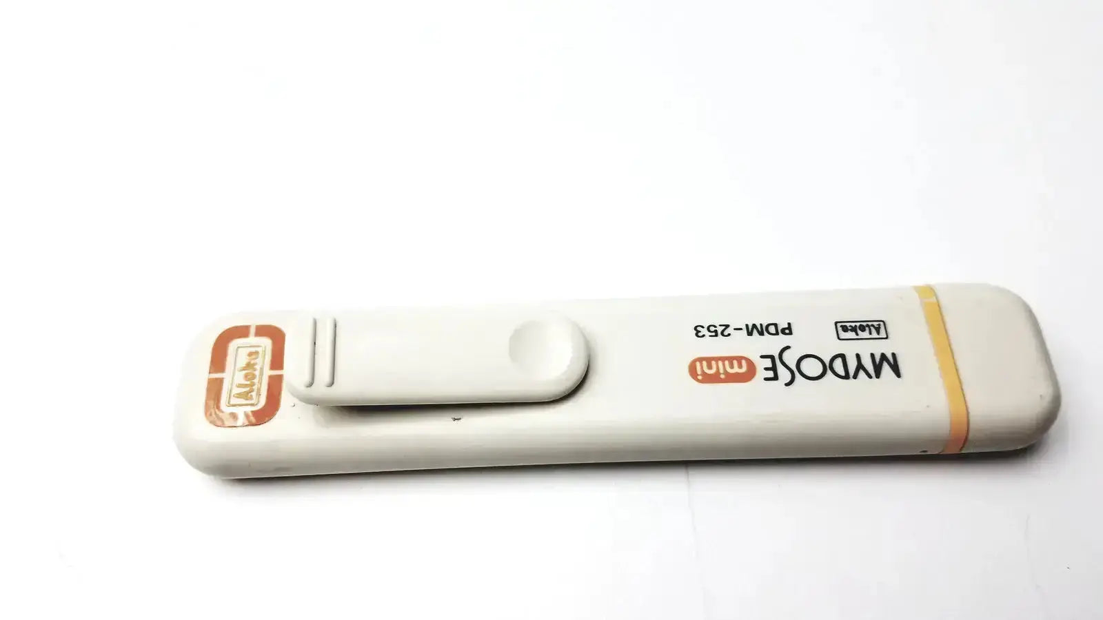 White plastic mydose mini dosimeter with orange branding and yellow stripe for blood glucose monitoring