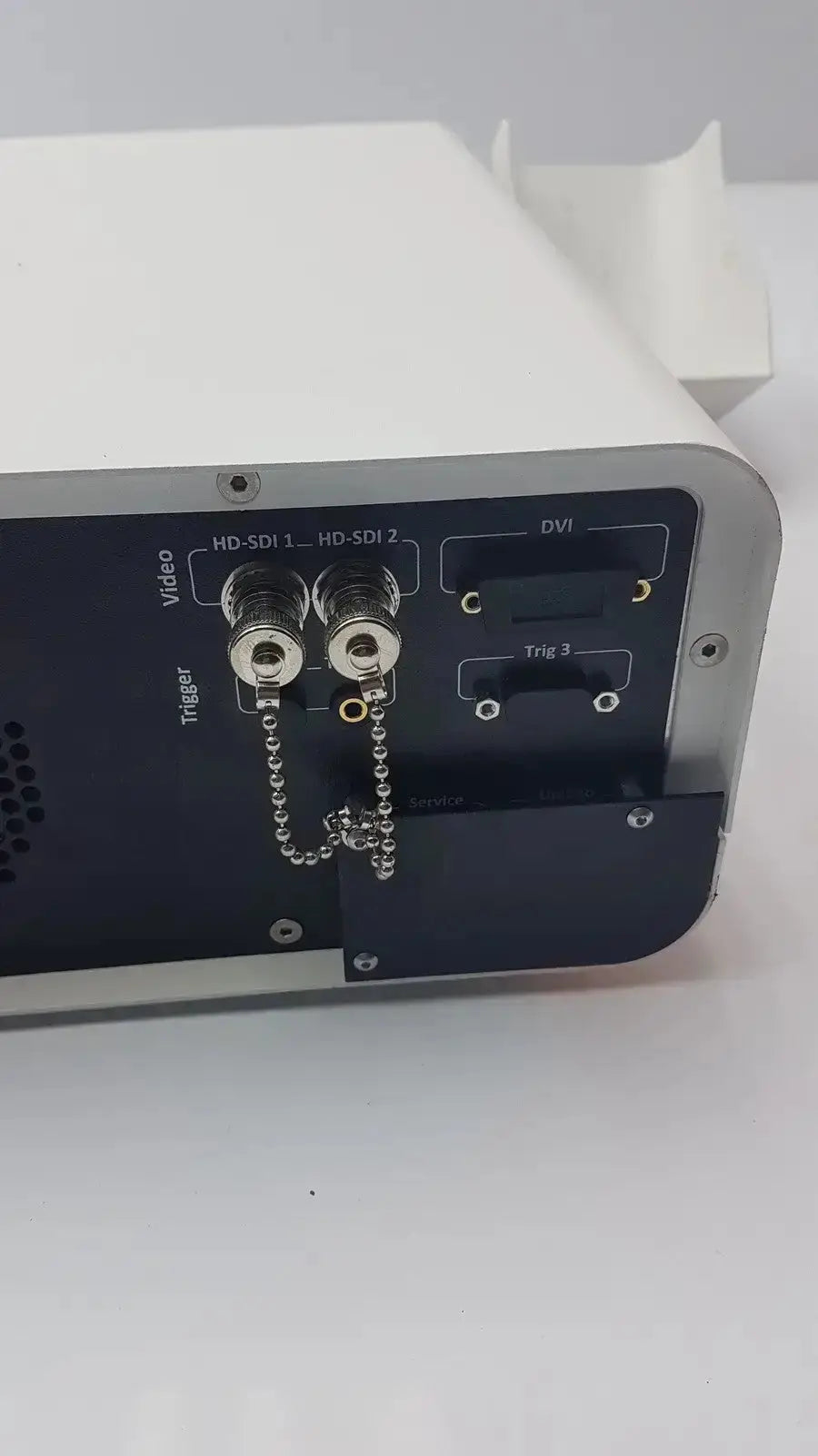 White and black ambu abox duodeno electronic device with hd-sdi and dvi ports and silver metallic trim shown from back side