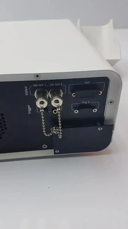 White and black ambu abox duodeno electronic device with hd-sdi and dvi ports and silver metallic trim shown from back side
