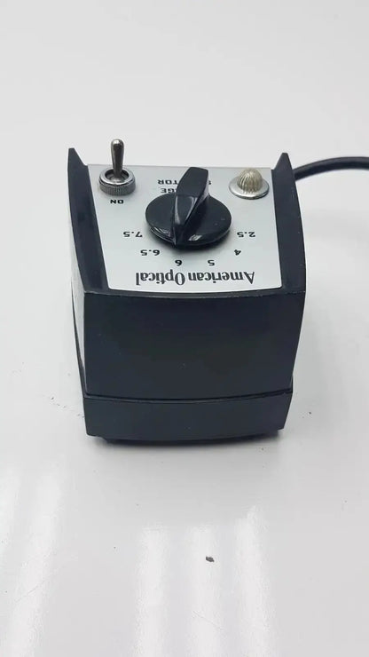 Black american optical voltage selector pri 115v with central black knob silver toggle switch and metallic dial made in usa