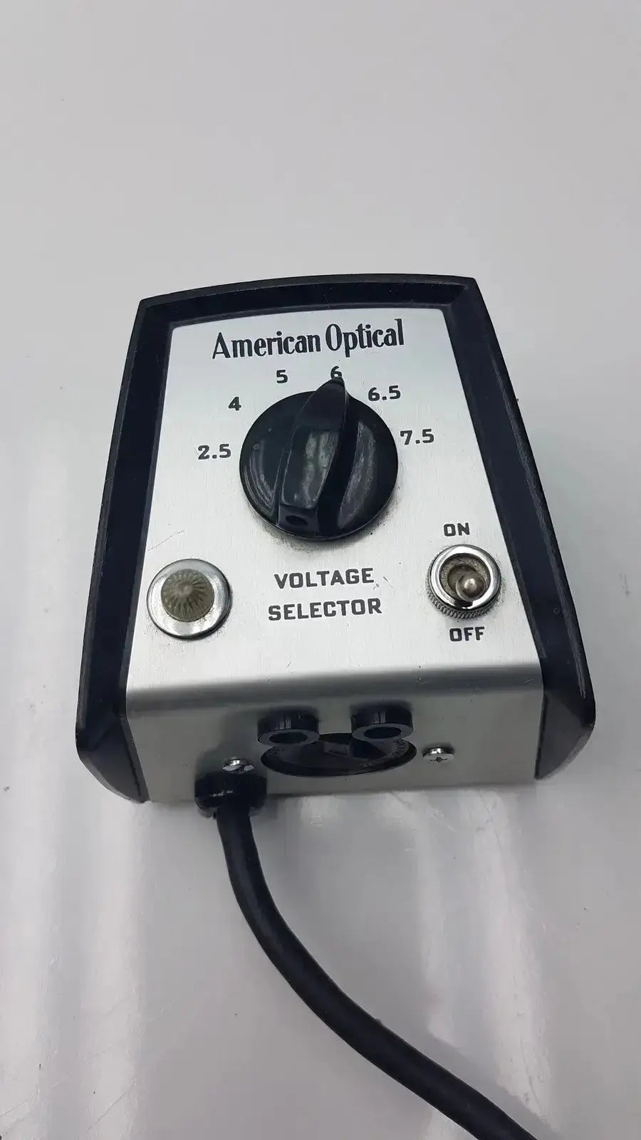 Silver and black american optical voltage selector pri 115v with rotary dial 2.5 to 7.5 volts and input ports made in USA