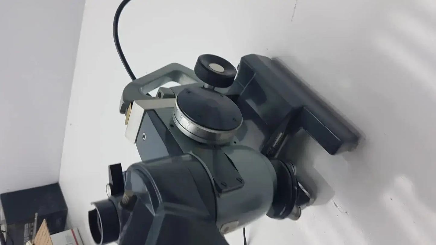 Dark gray industrial-grade optical AO micro star microscope with metallic components and black cable by American Optical