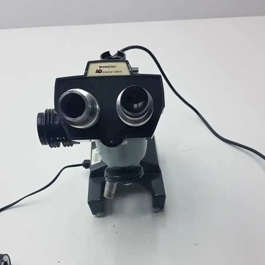 Black and gray optical ao micro star microscope with dual eyepieces labeled american optical model K-2301