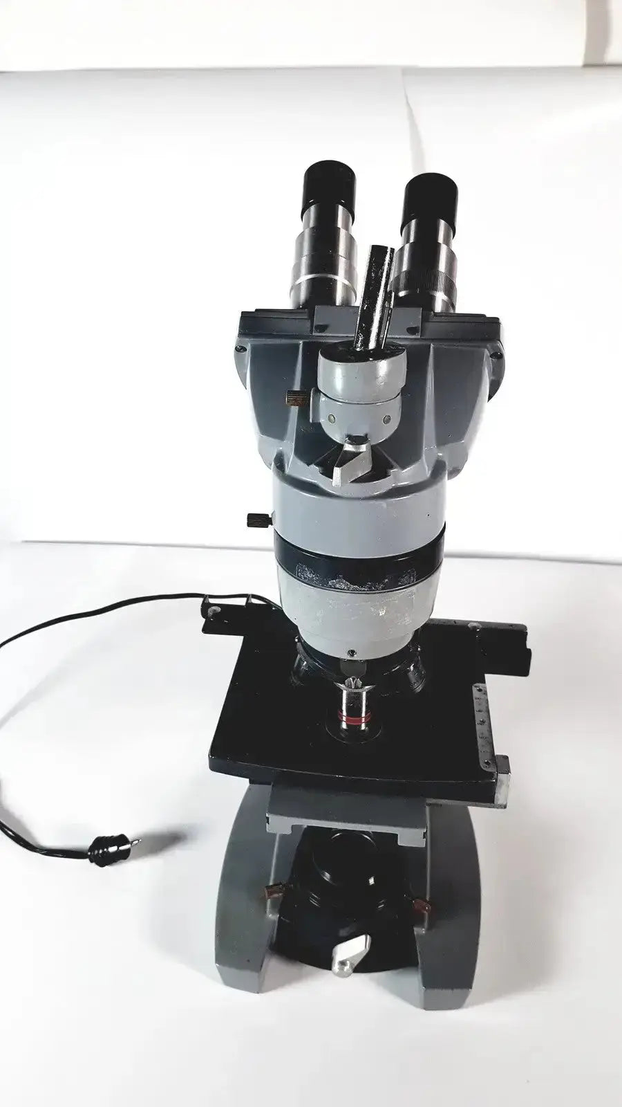 Black and silver american optical spencer compound microscope with dual eyepieces and sturdy base for precise viewing