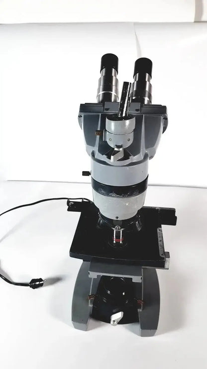 Black and silver american optical spencer compound microscope with dual eyepieces and sturdy base for precise viewing