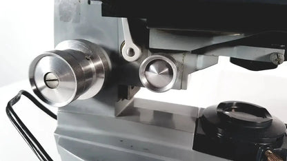 Silver metallic knurled focus knobs on an american optical spencer microscope for precise optical adjustments