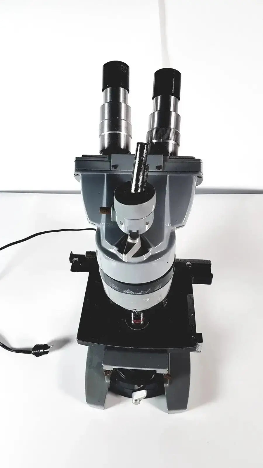 American Optical Spencer compound microscope in black and silver with dual eyepieces and adjustable stage