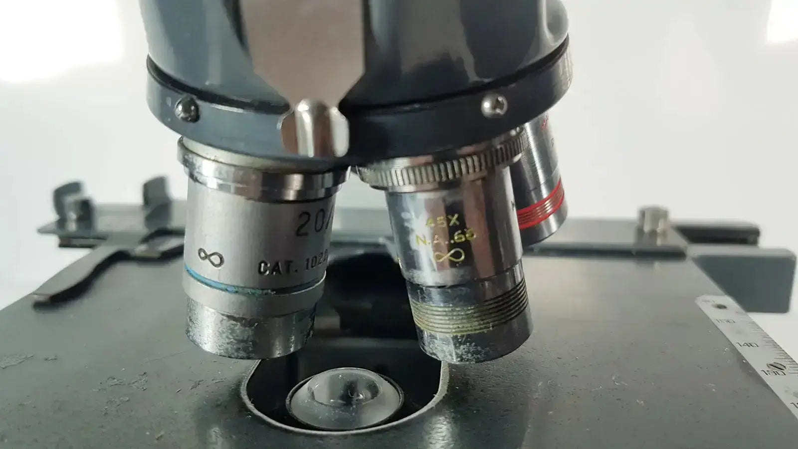 Black and silver american optical spencer microscope with labeled objective lenses for precise optical analysis