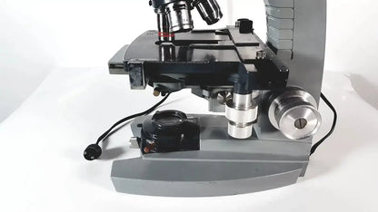 Gray and black american optical spencer microscope with metallic components for precise laboratory use