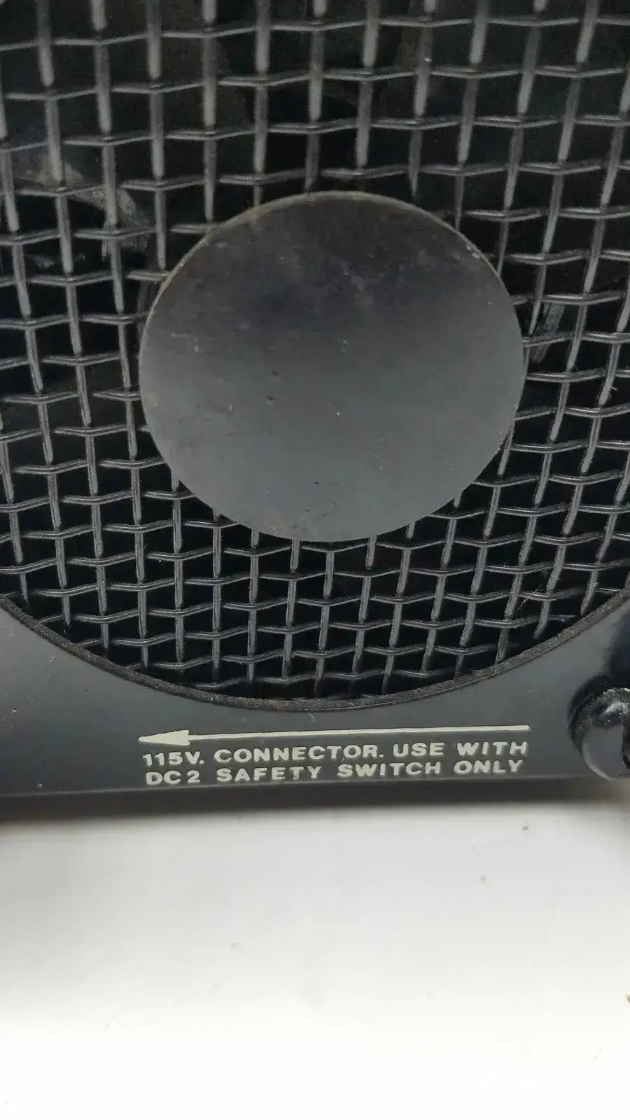 Black mesh-covered fan with circular grille and safety instructions on the back of amicon model lp-1 peristaltic pump
