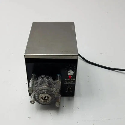 Silver and black amicon model lp-1 peristaltic pump with transparent tubing fittings and cole parmer pump heads 7015