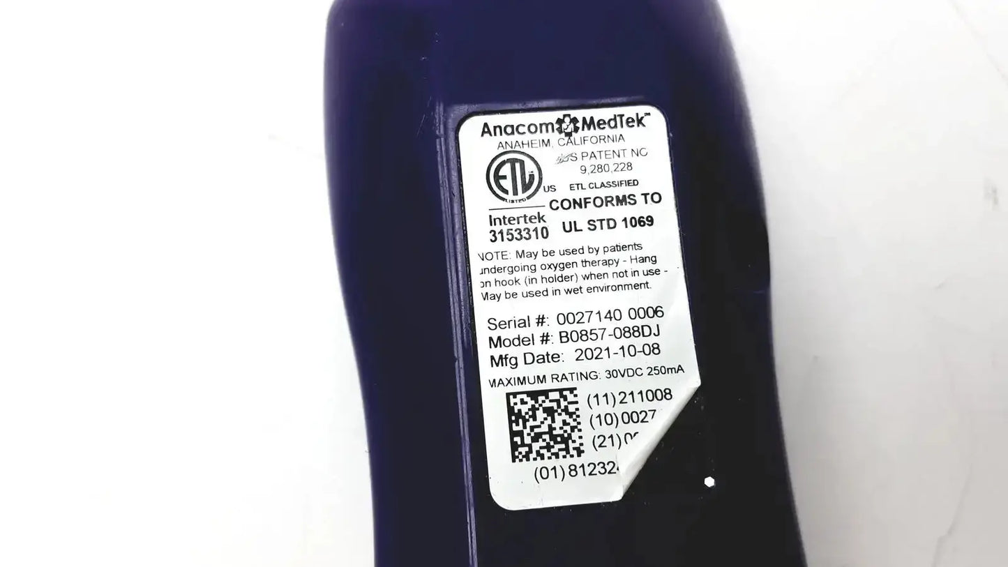 Dark blue anacom medtek b0857-088dj oxygen delivery device with white label showing model and serial info for nurse call unit