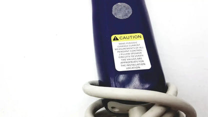 Dark blue anacom medtek b0857-088dj nurse call unit with yellow caution label and coiled beige cable at base