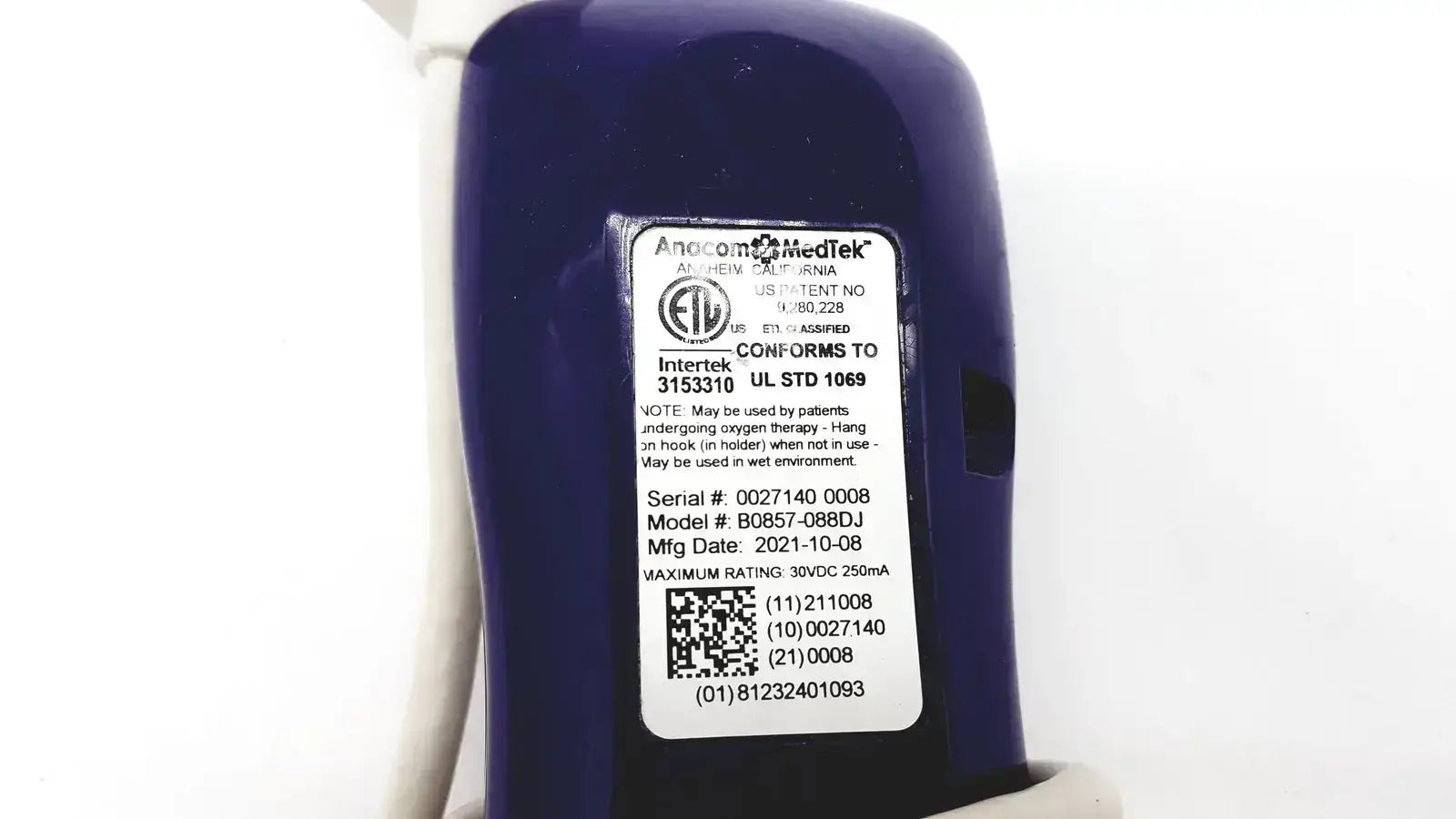 Dark blue cylindrical medical oxygen concentrator with white label showing model and serial number anacom medtek b0857-088dj nurse call unit