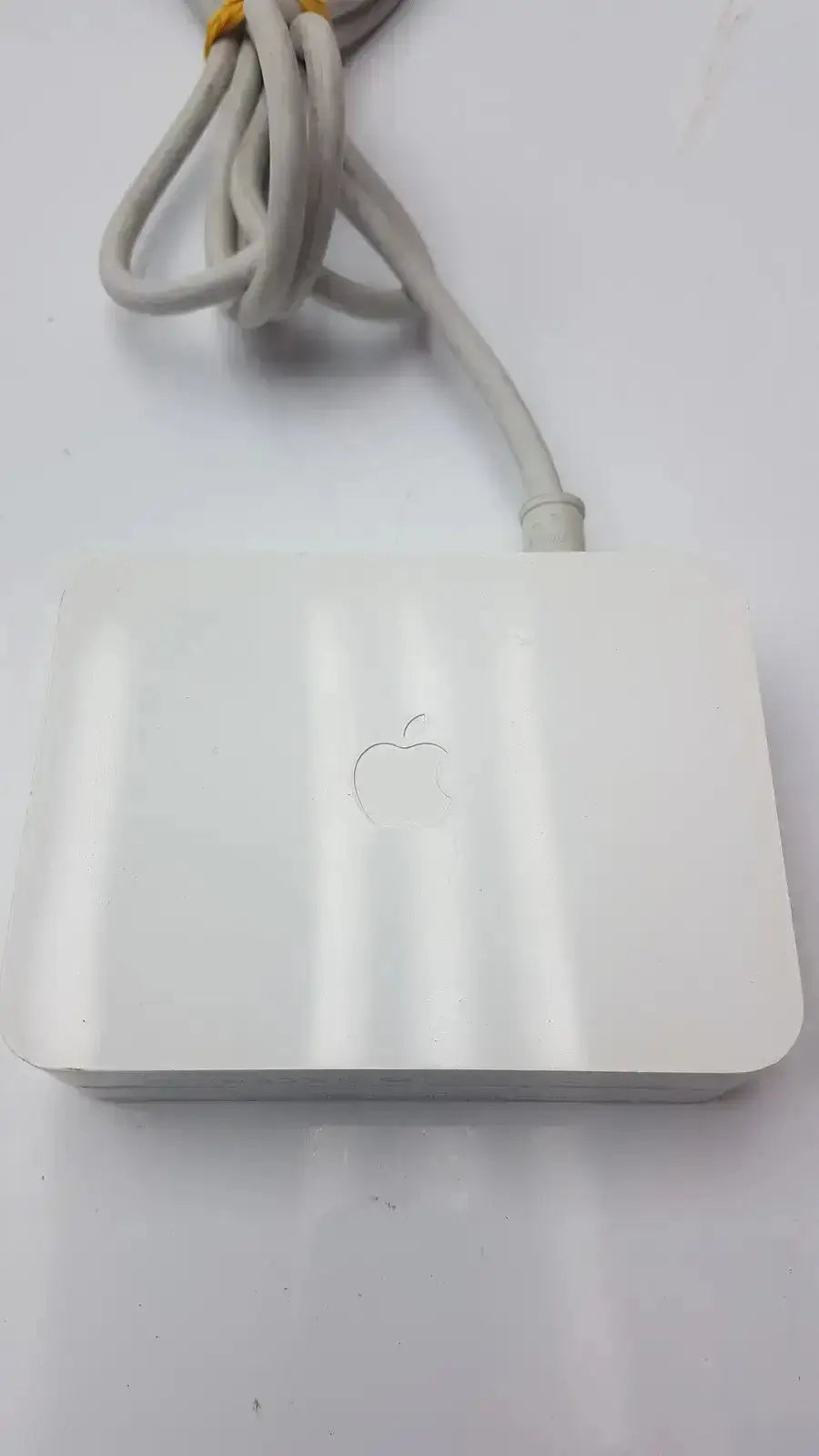 White apple airport express wireless router with matte finish and apple logo featured with cinema hd display 90w power adapter