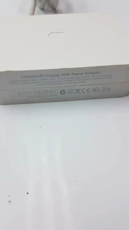 Silver rectangular power adapter labeled cinema hd display 90w power adapter for apple cinema hd display a1097