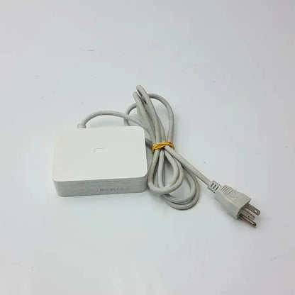 White Apple cinema HD display 90w power adapter with a coiled gray cable and yellow tie for MagSafe connection