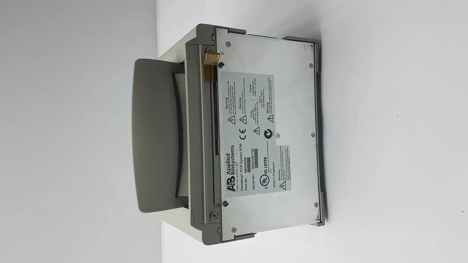 Gray applied biosystem geneamp thermal cycler with sleek rectangular design and visible specification label