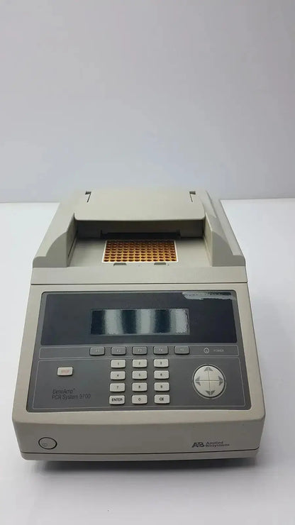 Beige rectangular applied biosystem geneamp thermal cycler with digital display and keypad for pcr amplification
