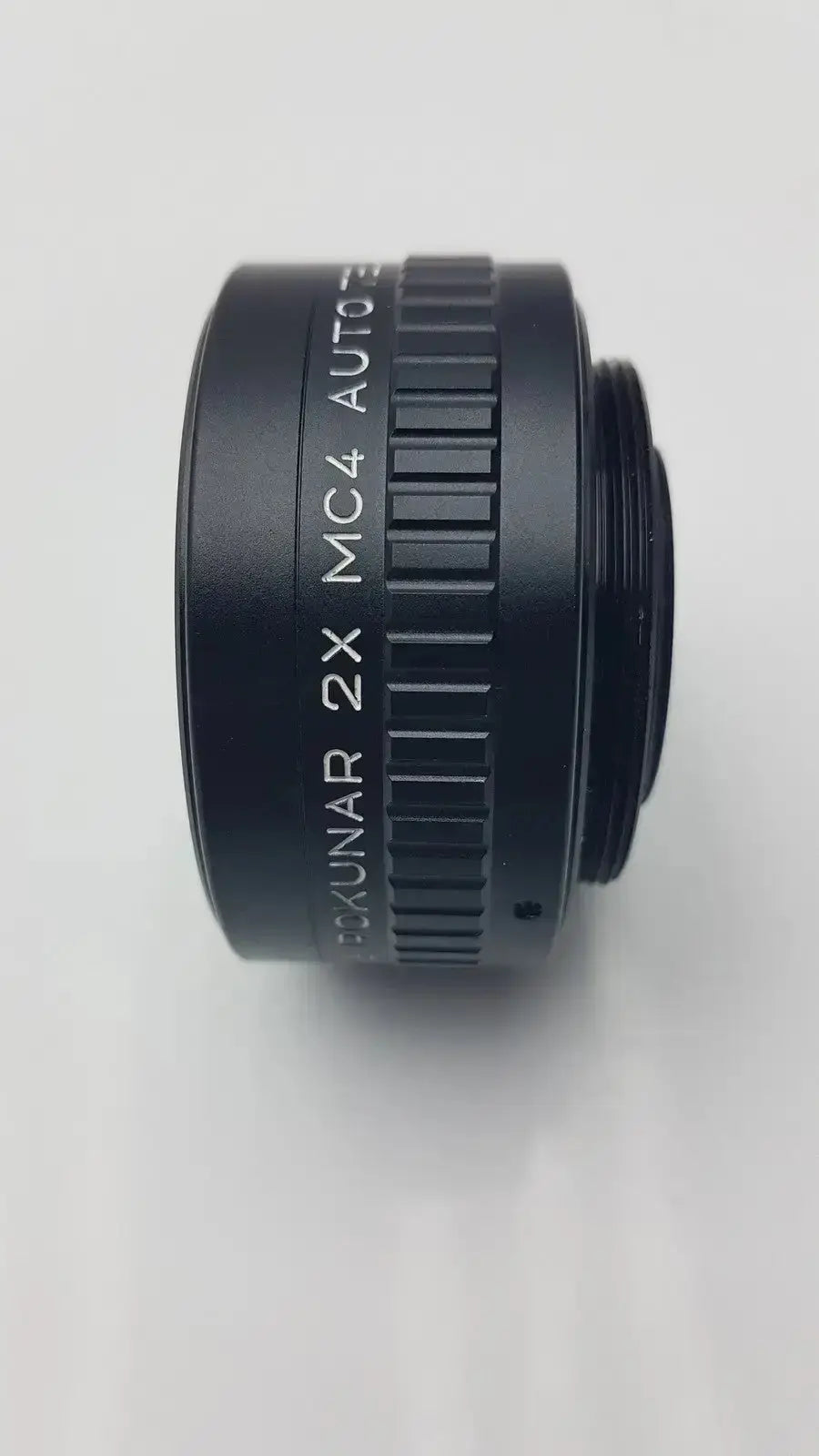 Black rokunar 2x mc4 auto tele converter lens adapter with textured grip and engraved kunar mc4 auto text
