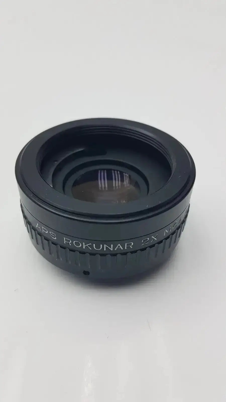 Black aps rokunar 2x mc4 auto tele converter lens with textured grip ring and engraved rokunar branding