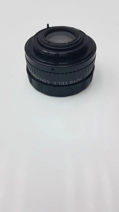 Black plastic APS Rokunar 2x MC4 auto tele converter lens with engraved text on barrel for photography use