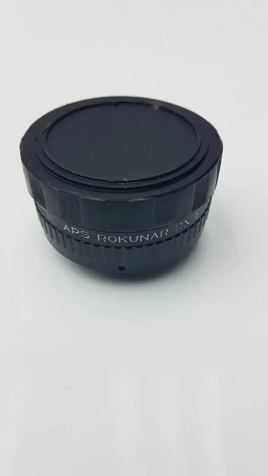 Black aps rokunar 2x mc4 auto tele converter lens adapter with textured ridges and smooth circular cap