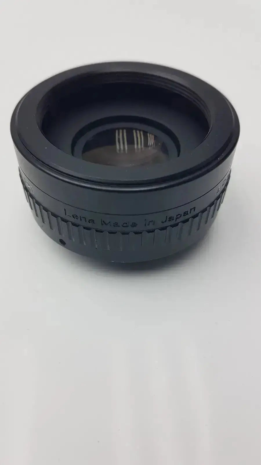 Black cylindrical APS Rokunar 2x MC4 auto tele converter lens adapter with textured grip ring and lens made in Japan engraving